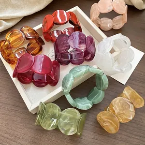 Chic marbled acrylic link bracelets in various colors displayed on a white tray