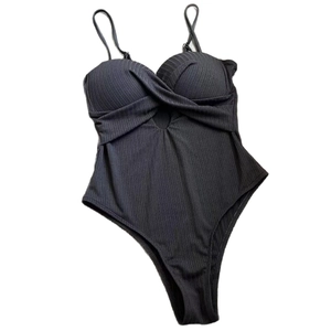 One-piece ribbed black swimsuit featuring front twist cut-out and high-cut leg design