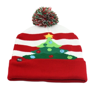 Detail of ON/OFF power button on a colorful LED Christmas knitted hat with stripes