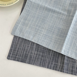 Close-up of woven cotton linen placemats with minimalist grid patterns for home dining