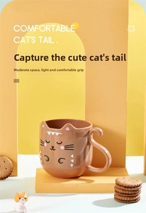 Detail view of the ergonomic cat tail handle on a brown ceramic mug for kids