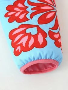 Detail of elastic sleeve cuffs on vibrant blue floral print padded cotton jacket