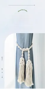 Detail of macrame woven cotton curtain tieback with decorative handmade tassels
