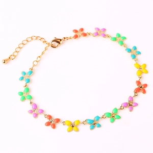 Detail of golden bracelet featuring colorful enamel butterfly charms and lobster clasp