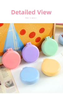 Detailed view of colorful pastel folding hairbrushes with makeup mirrors in various colors