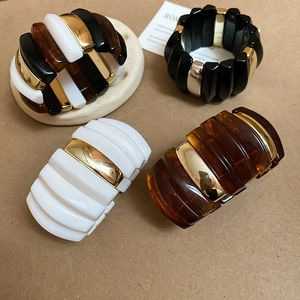 Detail of vintage acrylic cuff bracelets with tortoiseshell pattern and metal beads