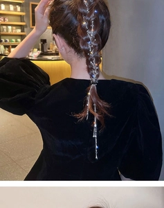 Close-up of sparkling rhinestone tassel hair chain woven into a braided ponytail