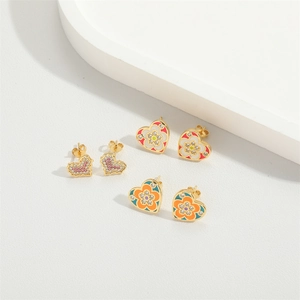 Three pairs of heart stud earrings with colorful enamel floral patterns and pink crystals