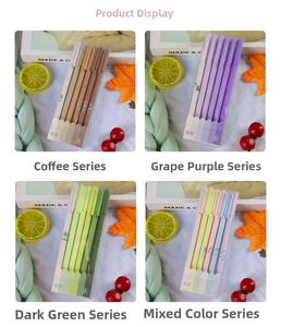 Close-up of four Morandi color gel pen sets in transparent boxes with cozy autumn decor