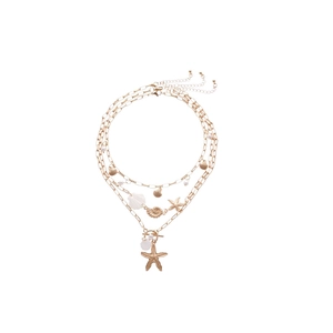 Bohemian gold layered necklace with starfish shell sea snail and pearl pendants