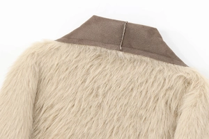 Detailed close-up of the plush faux fur collar and suede texture on this long coat