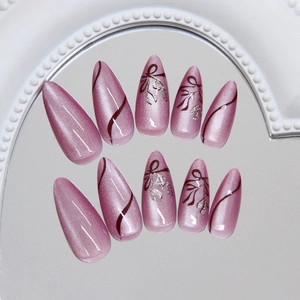Pink cat eye press on nails with long almond shape and hand-painted ribbon bow design