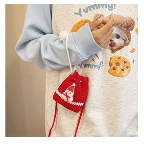 Detail of red handmade crochet Christmas bag with snowman motif and drawstring closure