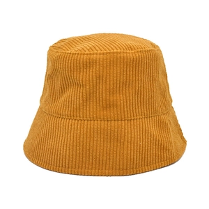 Close-up of yellow corduroy bucket hat showing soft wide-ribbed fabric texture