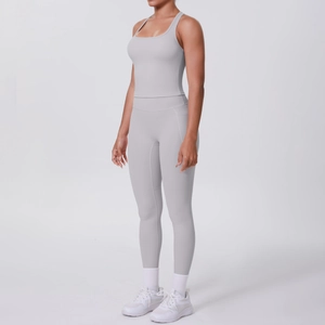 Detail view of high-waist yoga leggings with side pockets and racerback sports bra