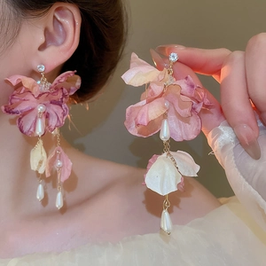 Detail of floral tassel earrings with pink gradient petals, pearls and crystals