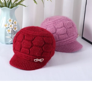 Detail of knitted winter hat with plush texture and decorative rhinestone bow