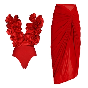 Detail view of red V-neck ruffle swimwear top and matching pleated long skirt set