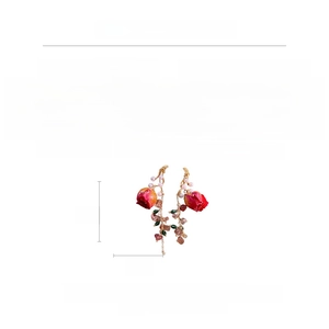 Macro detail of floral drop earrings with strawberry quartz and pearl fringe elements