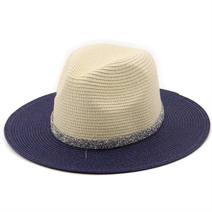 Detail of two-tone panama straw hat with ivory crown, navy brim and silver glitter band