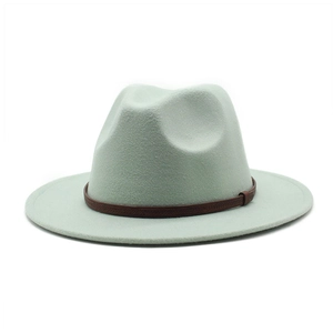 Detail of mint green wool fedora hat featuring a brown leather band with braided texture