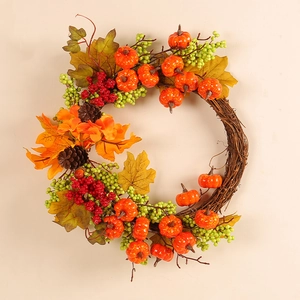 Autumn wreath featuring maple leaves, pumpkins, berries and pine cones on a vine base