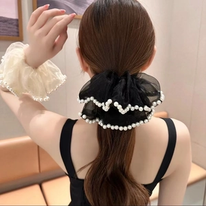Elegant organza lace scrunchie with pearl beads shown on hair for a stylish look