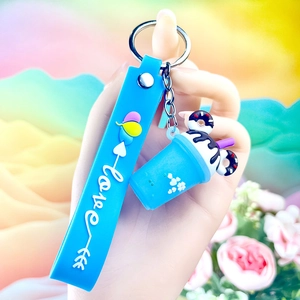 Close-up of blue silicone keychain with mini ice cream cup charm and 'love' printed lanyard