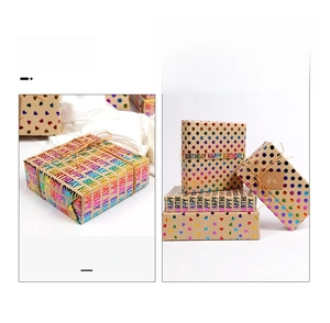 Close-up of birthday kraft wrapping paper with laser foil stars, hearts and jute twine tags