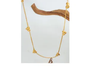 Detailed close-up of golden heart pendant necklace with shimmering zircon stones