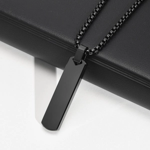 Detail of a minimalist black stainless steel rectangular bar pendant on box chain