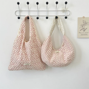 Close-up of pink lace floral tote and half-moon bag with white daisy embroidery