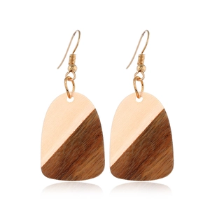 Detailed view of geometric resin and wood earrings with gold metal diagonal splice