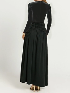 Full back view of elegant black long dress with velvet top and pleated flowy skirt