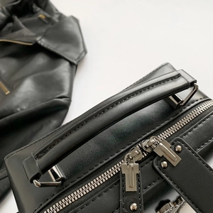 Chic black leather motorcycle crossbody bag with rivets and skull detail in 2025 style