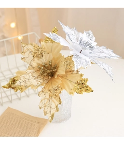 Detailed view of artificial Christmas poinsettia flowers with gold and silver sequins