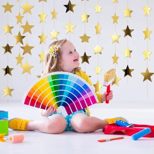Golden star paper garland for wedding and birthday party decorations in creative setting