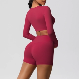 Rear view of tight-fitting berry red two-piece yoga set with long sleeves and high-waist shorts
