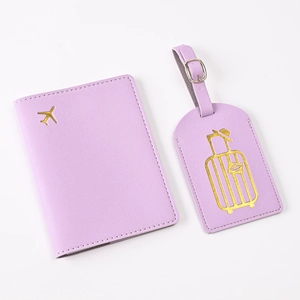 Detail of purple PU leather passport cover and luggage tag with gold embossed icons