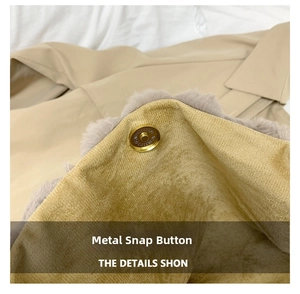 Detail of golden magnetic buckle and soft mustard velvet lining on the striped plush handbag