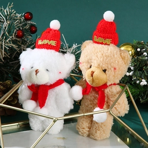 Cute Christmas plush teddy bears wearing red knit hats and scarves on festive green background