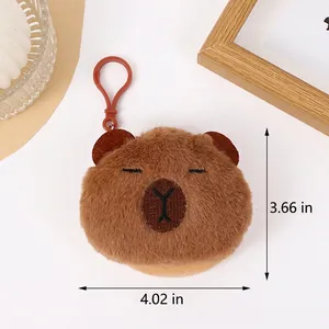 Detail view of a 9.3cm plush capybara coin purse with hook in a cozy lifestyle setting