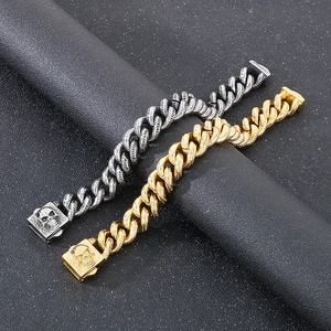 Macro detail of gothic skull buckle and engraved heavy metal chain bracelet in gold and silver