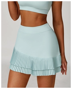 Detail of light blue high-waist pleated tennis skirt and matching crop top with pockets