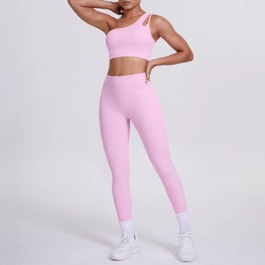 Pink one-shoulder cutout sports bra and high-waisted legging set on a studio model