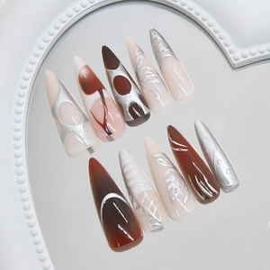 Metallic silver and brown stiletto press-on nails with 3D butterfly wings and abstract art
