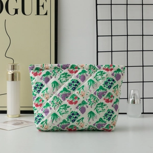Detail of floral quilted makeup bag featuring purple flower patterns and soft texture