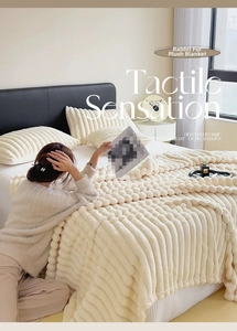 Detail of soft cream rabbit faux fur blanket with striped texture and matching pillowcase