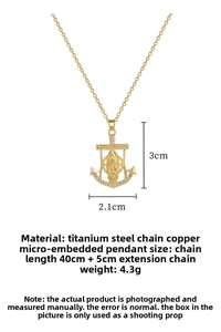 Detailed view of gold anchor pendant with Mary icon and shimmering cubic zirconia