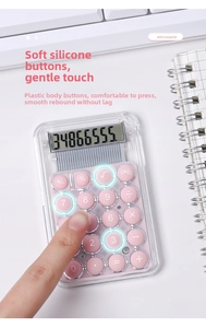 Detailed view of pink mini calculator with soft silicone buttons on a white desk